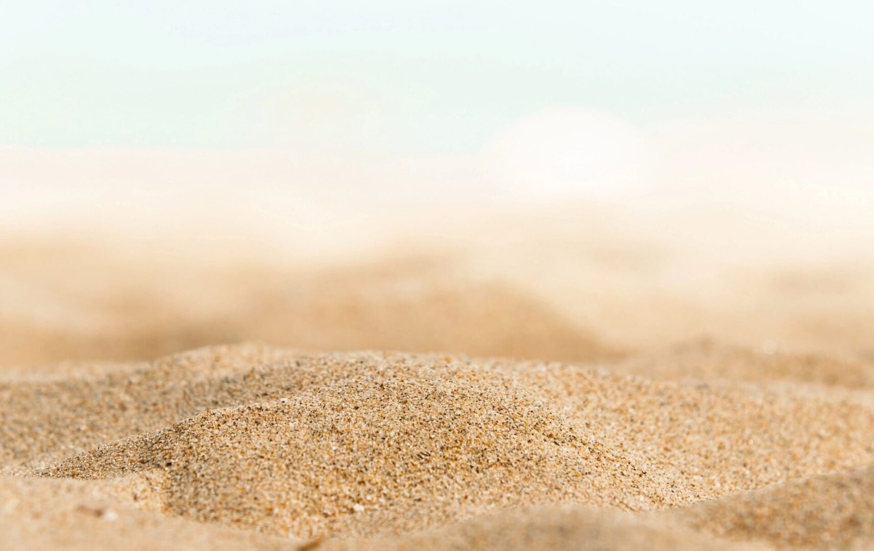 A close up of sand on the beach