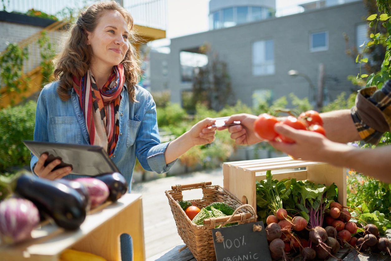 A woman is handing out food to someone else.