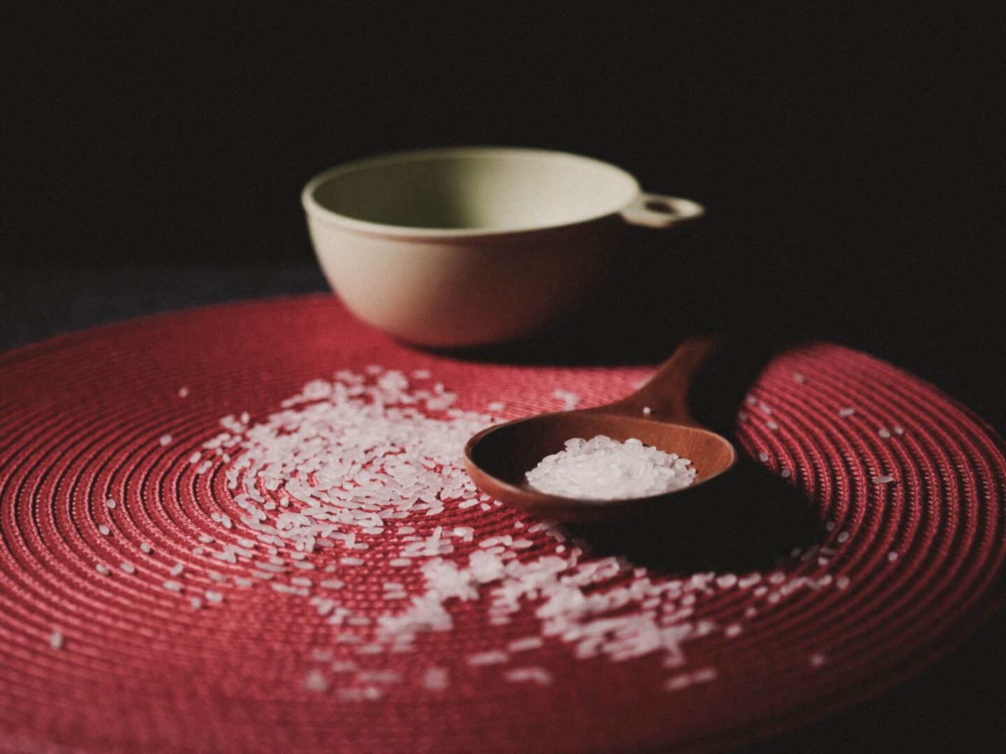 A spoon and bowl on the table with salt.