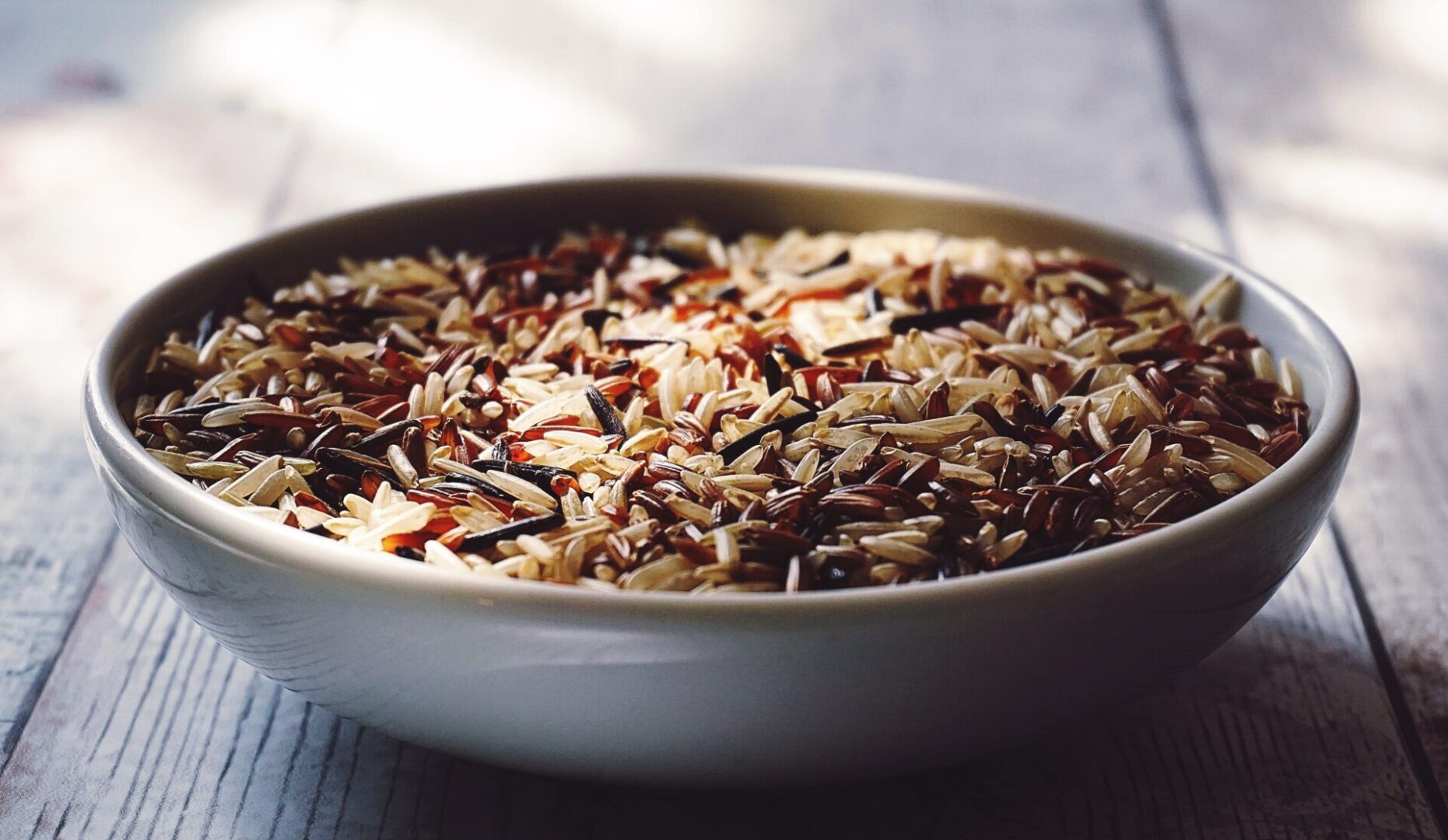 A bowl of rice with different types of food in it.